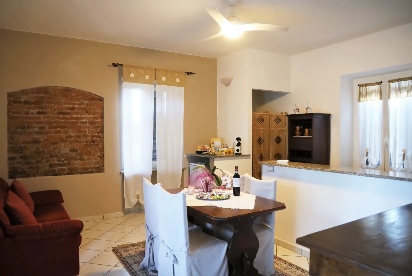 Il soggiorno dell'Appartamento Giada con il muro in mattoni